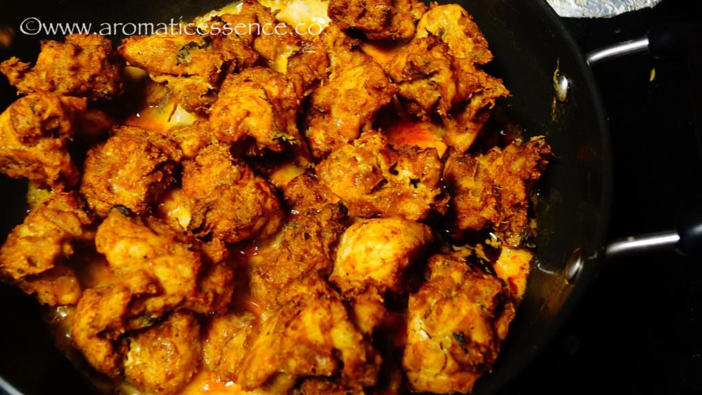 Add in the cooked chicken pieces and toss to coat evenly with the tempering and sauce