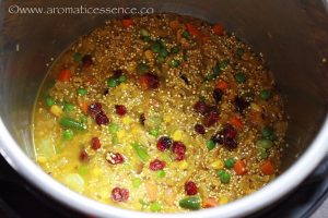 adding water to sauteed veggies and quinoa