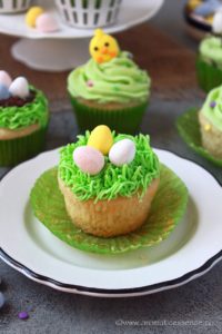 Eggless Easter cupcakes frosted with buttercream icing and topped with chocolate eggs