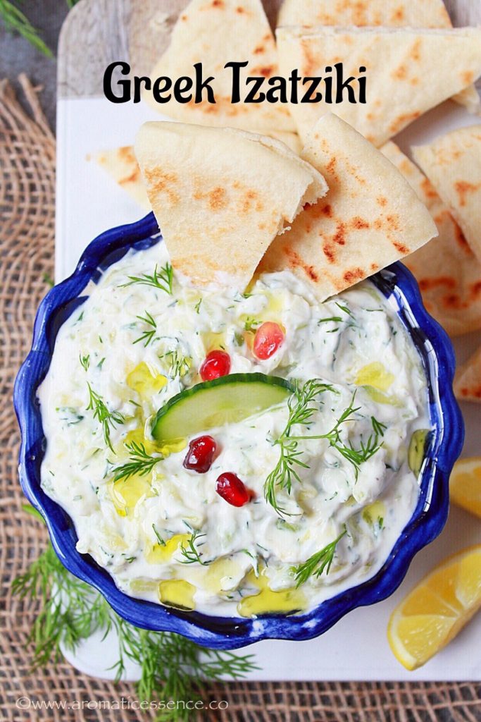 Tzatziki sauce in a bowl with pita bread