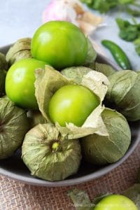 Tomatillos in a grey bowl.
