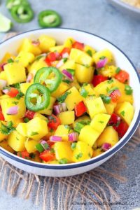 Mango salsa served in a white bowl.
