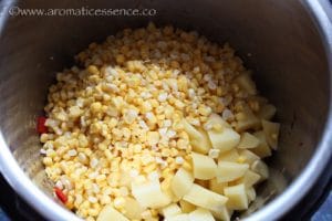 Add the corn kernels and potatoes.