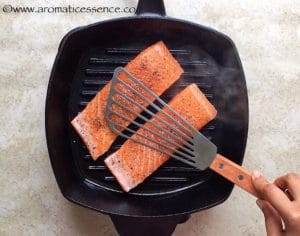 Press the fish down using a spatula.