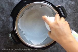 Line the inner pot with parchment paper, grease with oil spray.