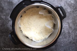 After 4 hours, remove the lid, the dough will have risen and the surface will be dotted with bubbles.