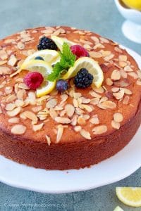 Lemon ricotta cake on a white cake stand