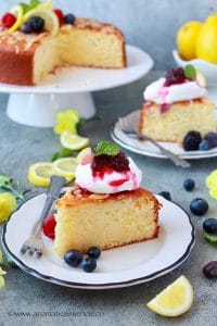 Two slices of lemon and ricotta cake served on white plates