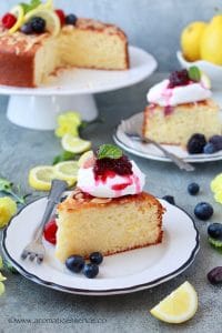 Two slices of lemon and ricotta cake served on white plates