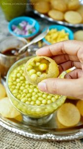 Puri filled with ragda, sweet chutney, and spicy water