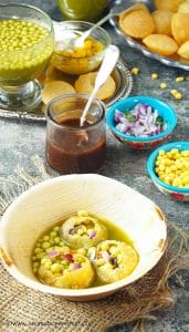 Three filled pani puris in a bowl
