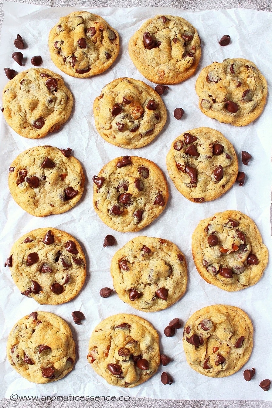 Eggless chocolate chip cookies on parchment paper.