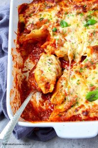Stuffed shell scooped on a serving spoon.