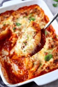 Stuffed shell pasta on a serving spoon