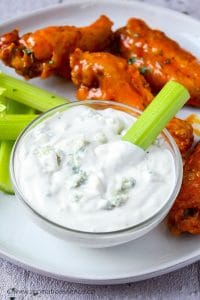 Celery stick dipped in blue cheese sauce