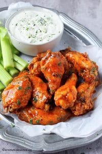 Oven baked buffalo wings served with chunky blue cheese dressing and celery sticks