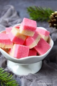 Coconut ice pieces piled in a white bowl