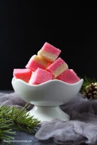 Coconut ice pieces in a white bowl