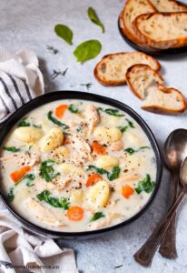 Creamy chicken gnocchi soup served along with crusty bread