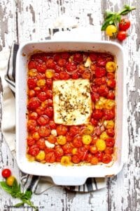 Roasted cherry tomatoes and feta cheese in a baking dish