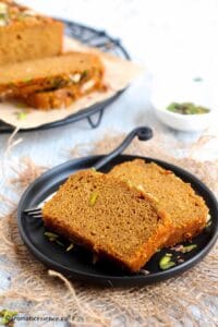 Two slices of wheat cake placed on a black rimmed plate