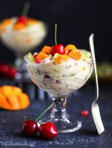 Creamy fruit salad served in a glass serving bowl