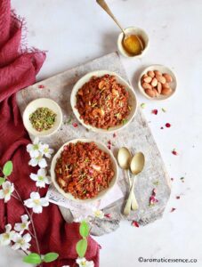 Gulachi lapsi served in two shallow whiet bwol garnished with pistachios and dried rose petals