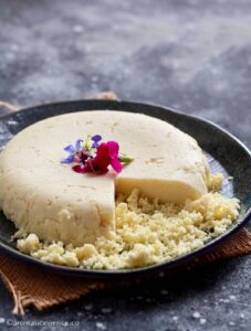 A portion of mawa crumbled on a plate