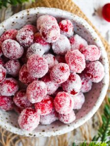 Overhead shot of sugared cranberries in a ceramic bowl