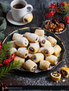 Dusting icing sugar on the date rolls
