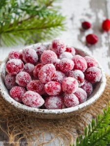 Candied cranberries in a speckled ceramic bowl