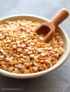 Raw toor dal in a small ceramic bowl