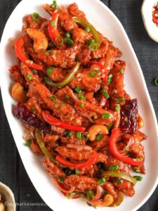 Close-up shot of dragon chicken garnished with spring onion greens