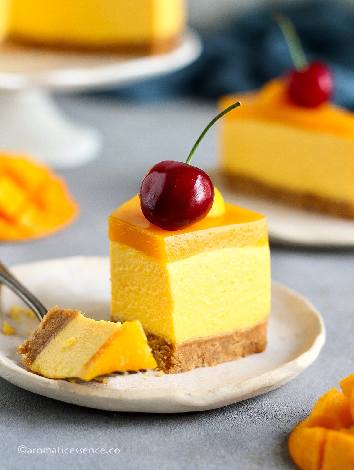 No-bake mango cheesecake slice on a plate with a fork