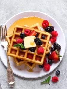 Close-up shot of eggless waffles on a white plate
