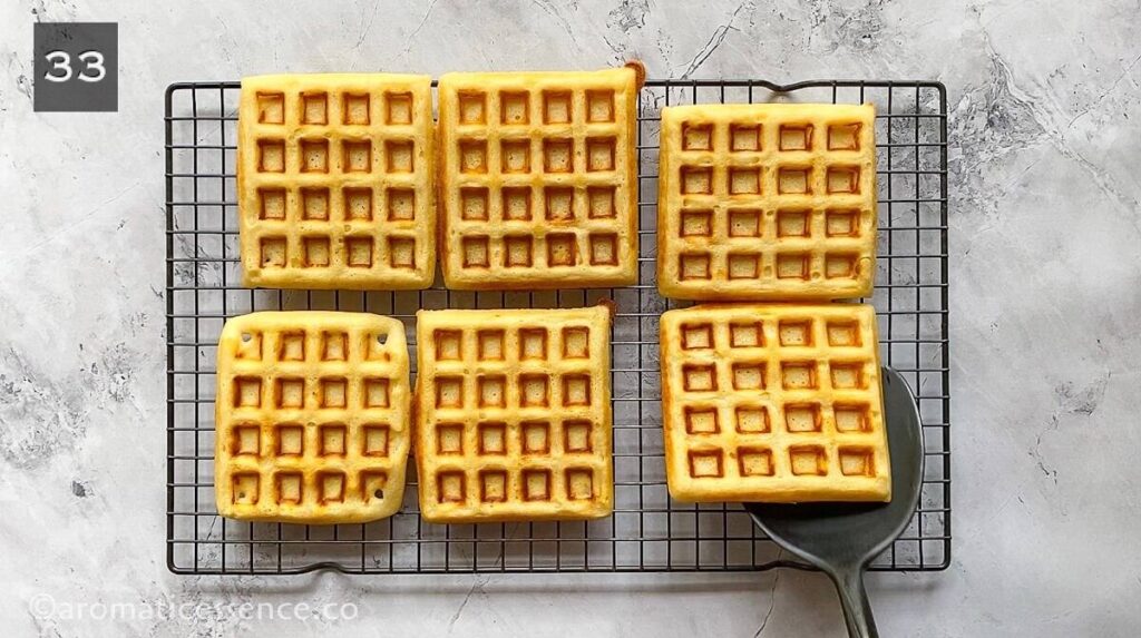 Cooked waffles placed on a cooling rack