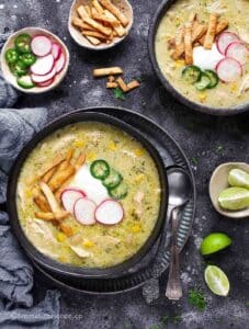 Instant Pot green enchilada chicken soup served in two black bowls