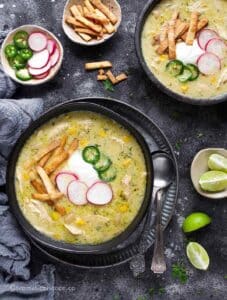 Instant Pot green enchilada chicken soup served in two black bowls