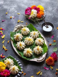45 degree angle shot of steamed modak's served with ghee