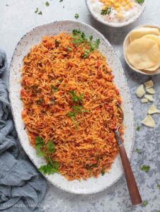 Thakkali sadam served in a white speckled irregular platter