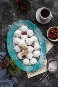 Mexican wedding cookies served in a blue ceramic platter